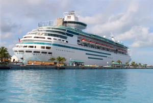 Cruise ship in the clear blue Caribbean ocean docked in the port of Nassau, Bahamas