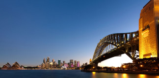 Sydney Harbour at dusk, with bridge on foreground